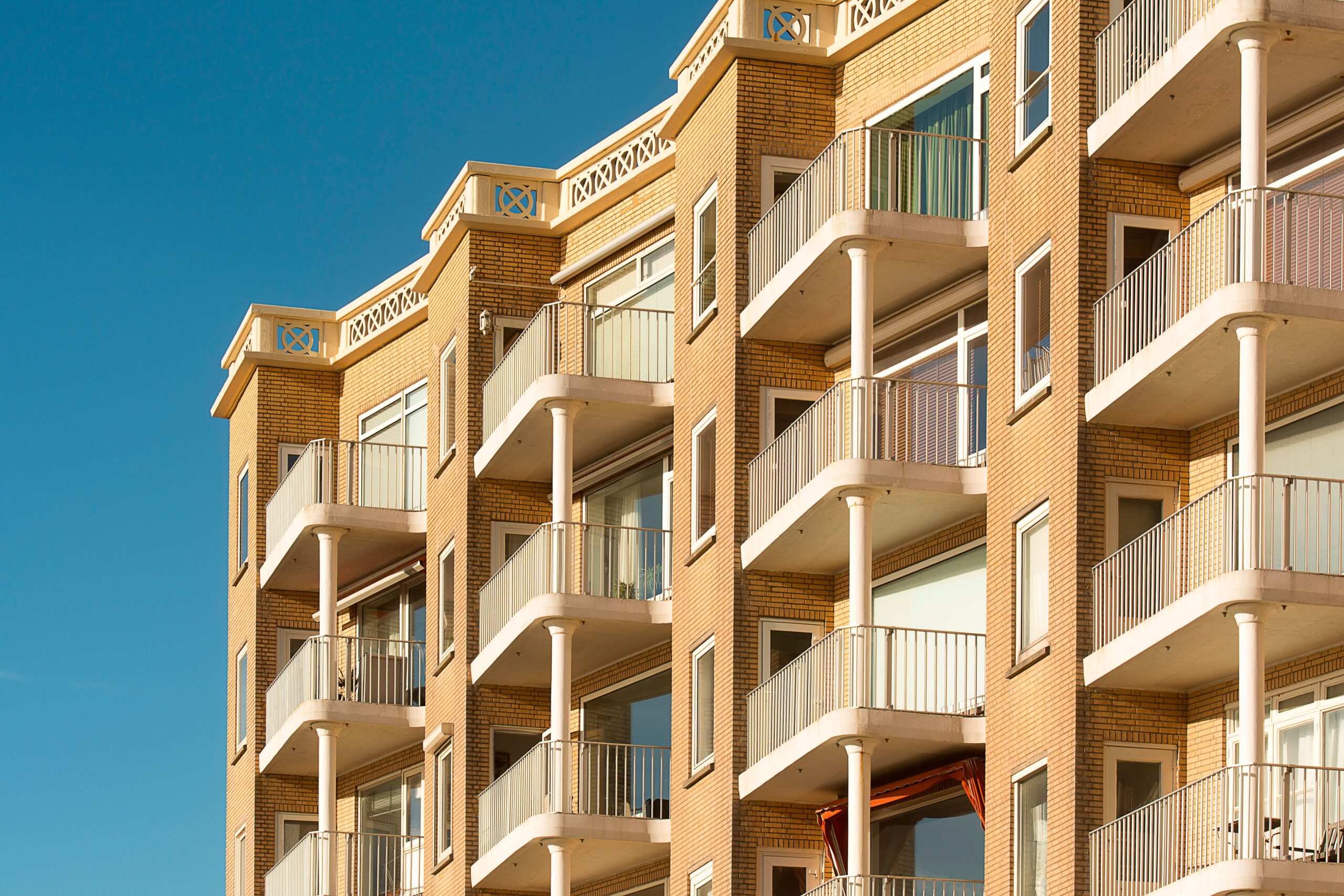 Home Contemporary apartment building featuring multiple balconies, ideal for urban living environments.