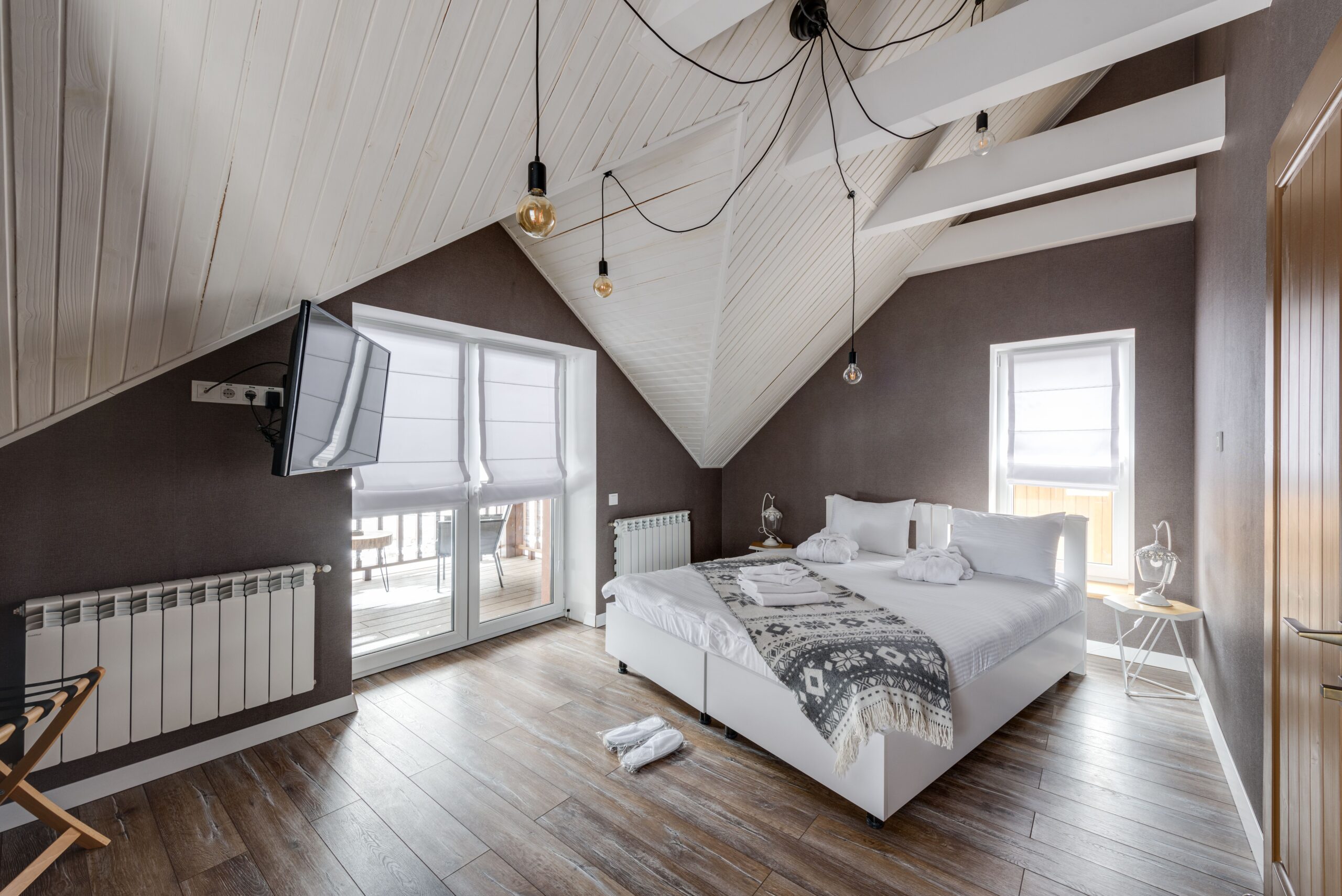 Home Stylish attic bedroom interior with modern furnishings and a cozy atmosphere.